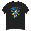 Detroit Motor Geese Goose Football Tee - cartoon goose football player in a blue uniform with a silver helmet, holding a football in front of stadium lights and goalposts, with "Detroit Motor Geese" arched above - Black front flat