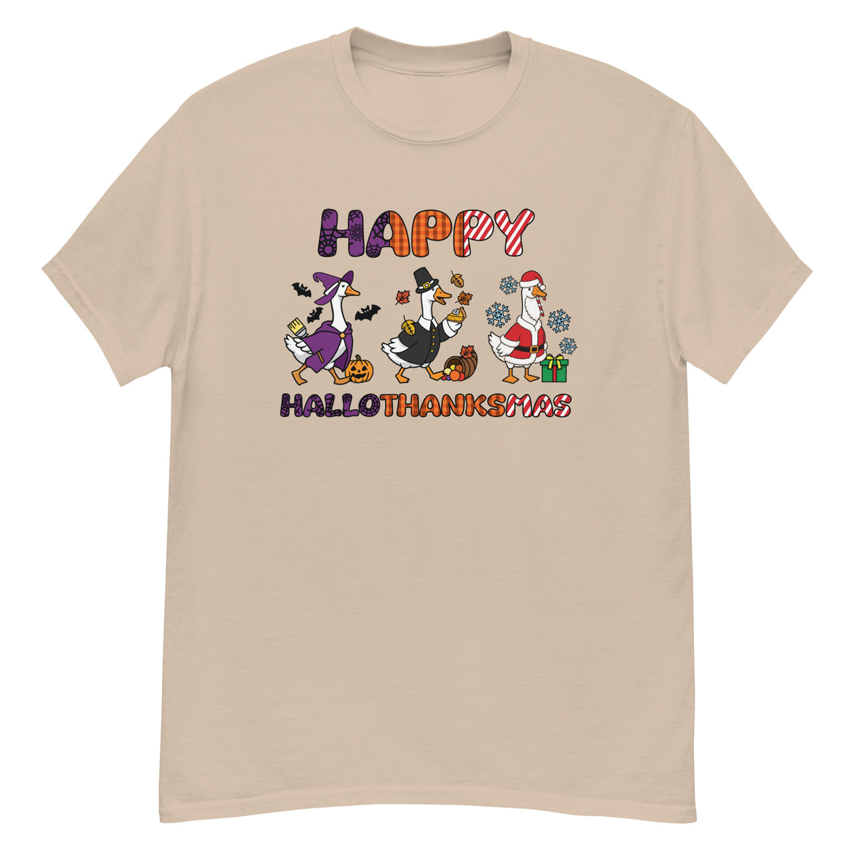 HalloThanksMas Tee - three geese dressed as a witch, pilgrim, and Santa, "Happy HalloThanksMas" - Sand front flat